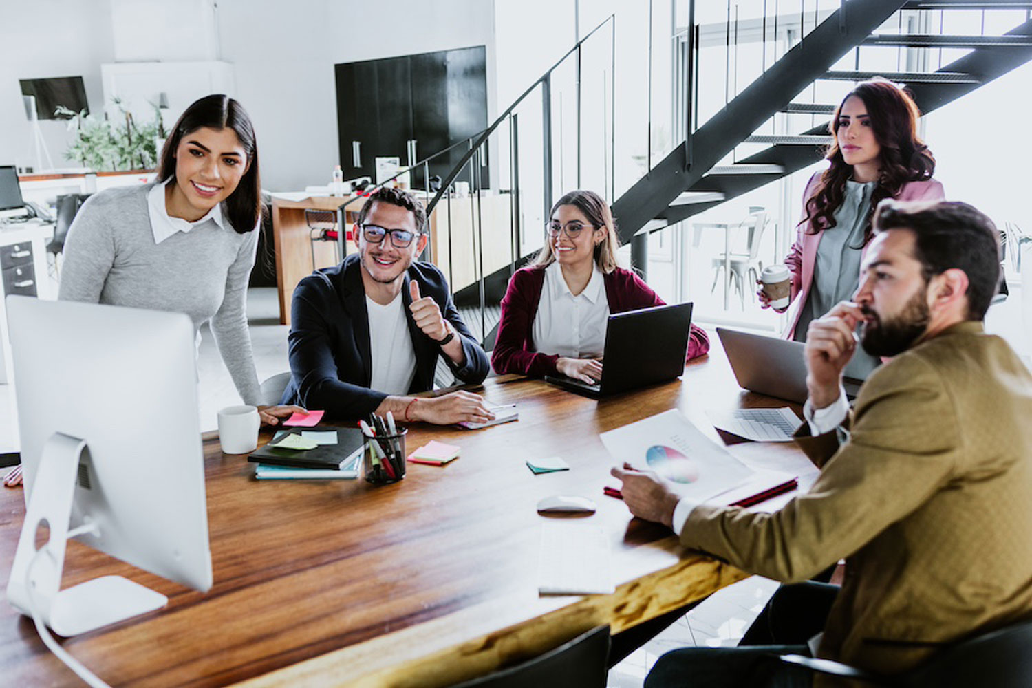 group of young professionals at conference table