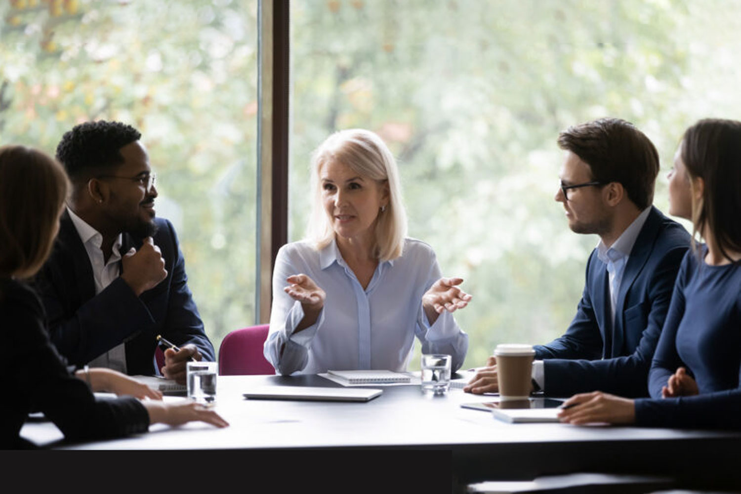 5 business people at conference table