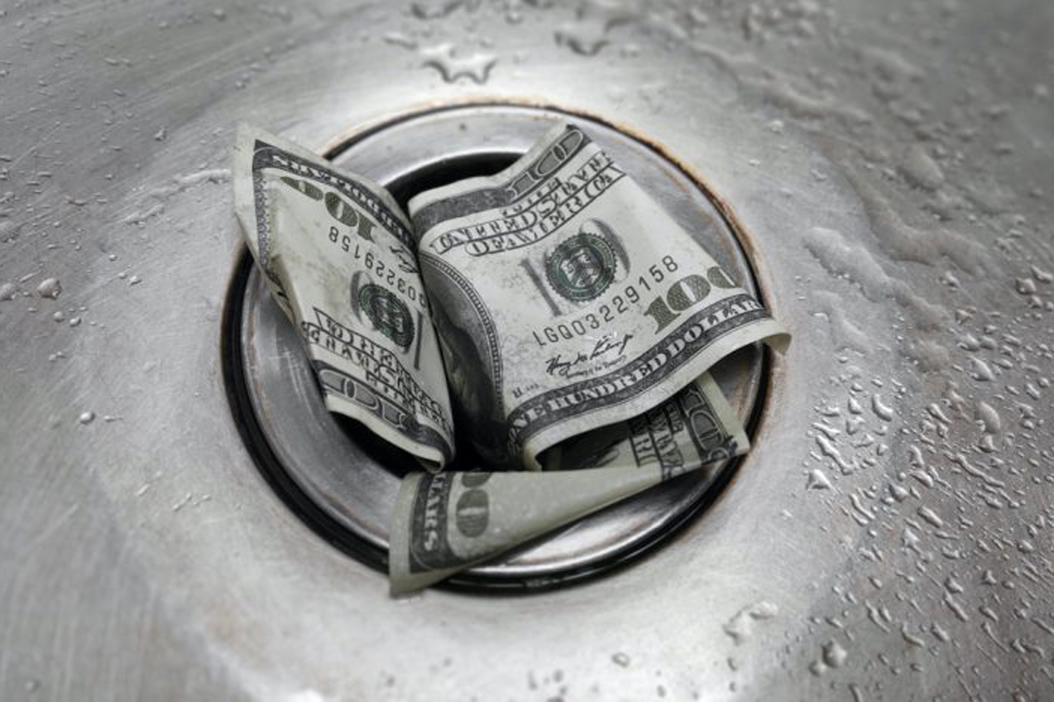 one hundred dollar bill going down drain