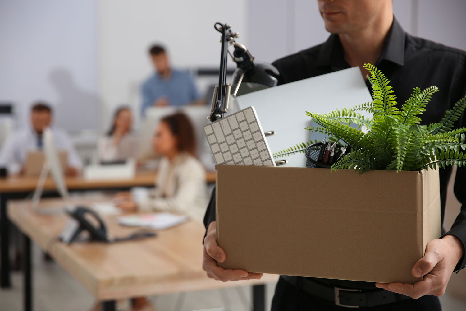 ManageChange man carrying cardboard box with office items