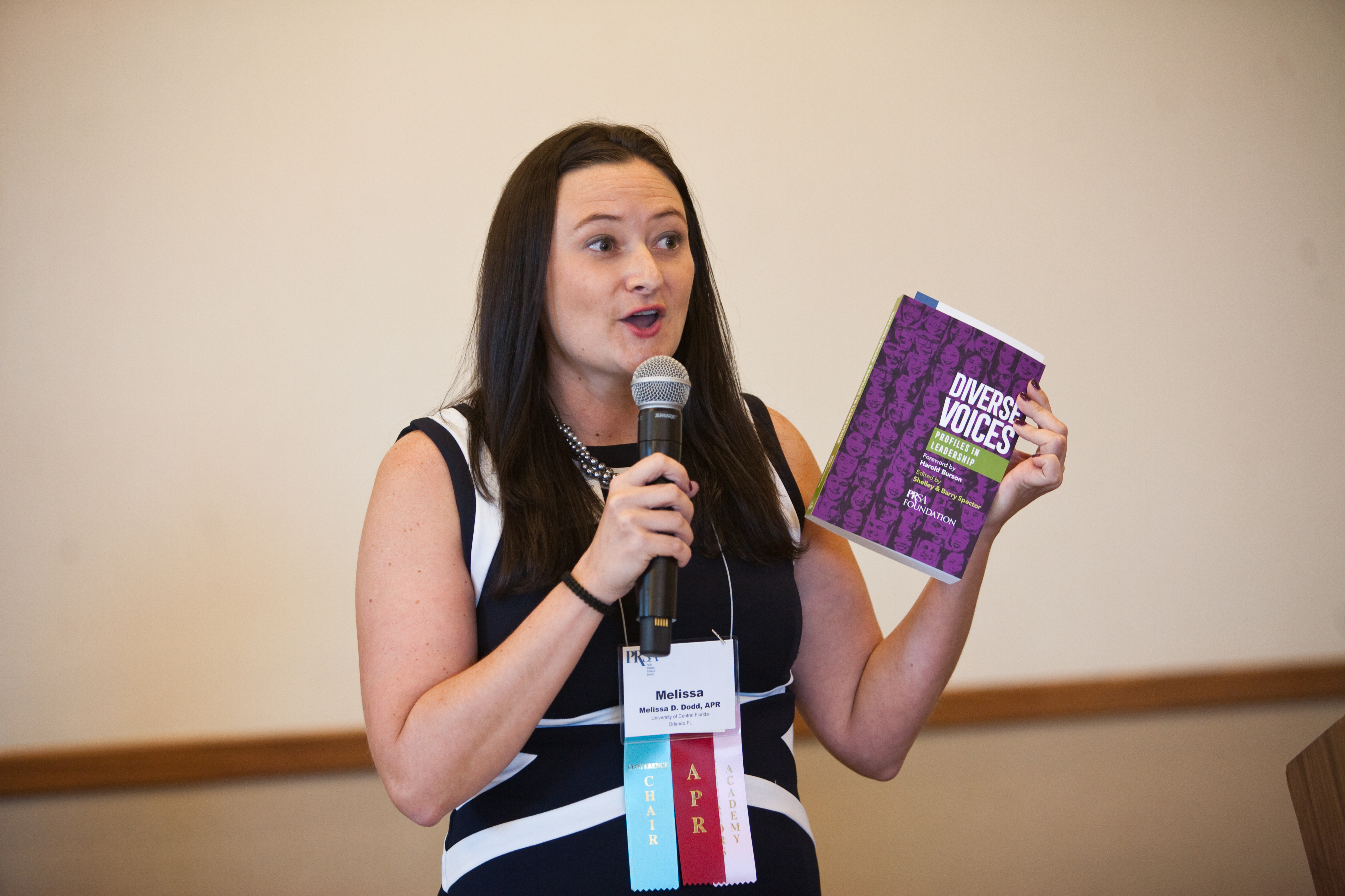 Diverse Voices Member holding a Diverse Voices book