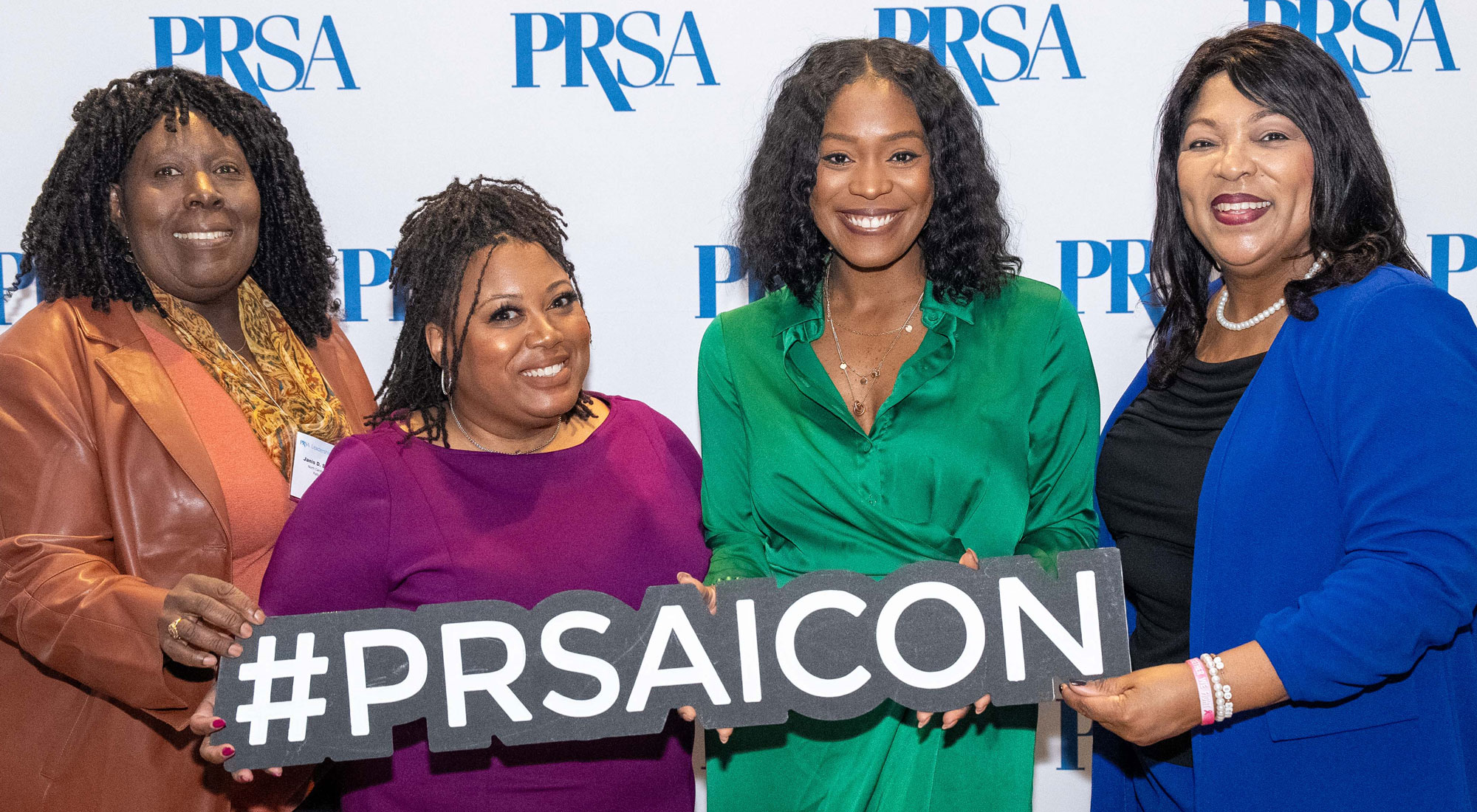PRSA ICON attendees holding hashtag sign PRSA ICON attendees holding hashtag sign