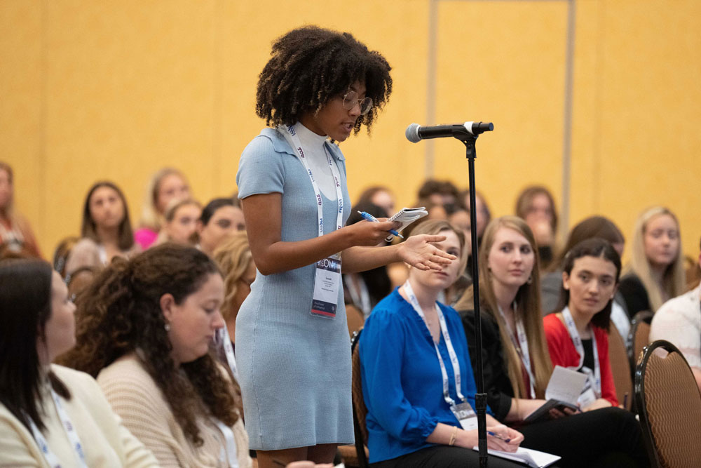student speaking at microphone student speaking at microphone