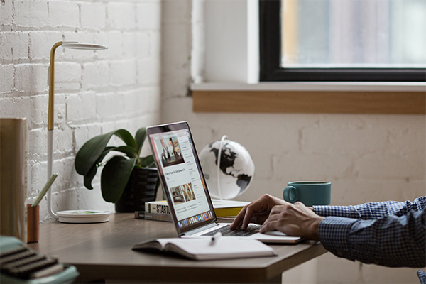 Man reading news at his desk